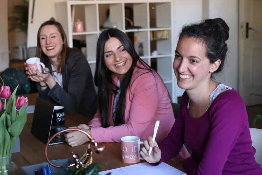 Women at a table laughing and talking