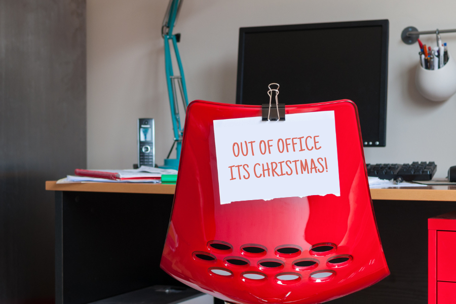 an empty desk saying "out of office its christmas"